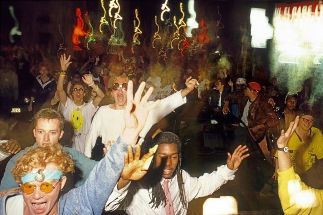 Ravers around a car on Tottenham Court Road