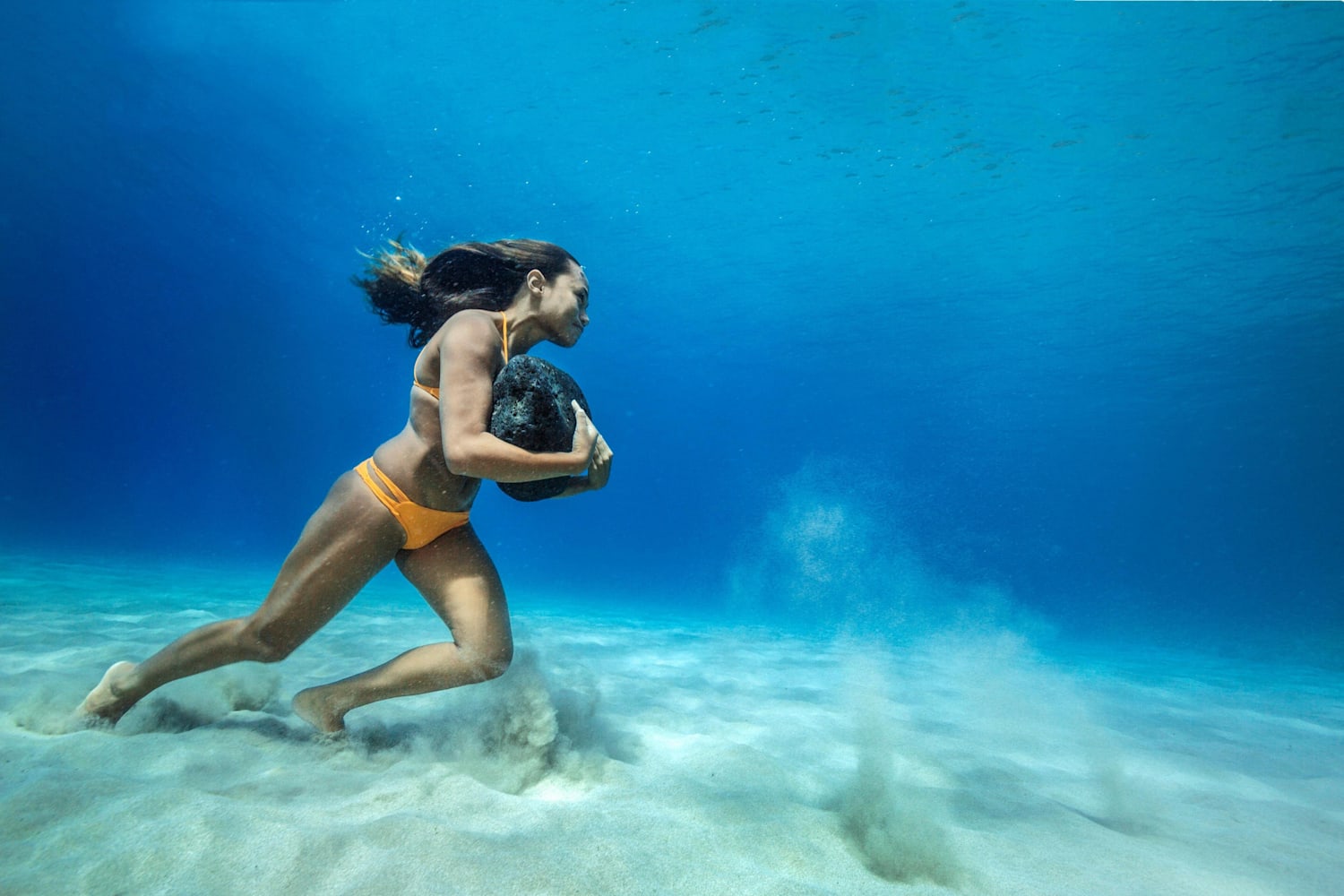 Surfer Ha'a Keaulana Trains Underwater with Boulders