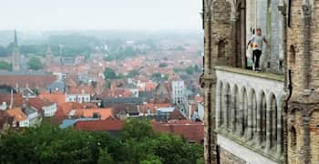Freerunner Dominic Di Tommaso balancing on a roof in Bruges, Belgium.