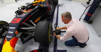 A Red Bull Racing team member works on one of the car's wheels at the the factory in Milton Keynes, UK.