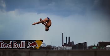 Cliff diver Jonathan Paredes is seen diving from a Red Bull board.