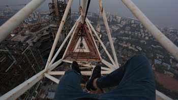GoPro of Vadim Makhorov hanging feet from a crane
