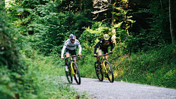 Lars Forster and Andri Frischknecht train on a road in Switzerland.