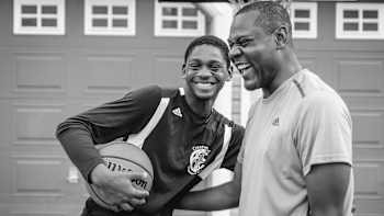 An image of 12-year-old basketball starlet Elijah Fisher with a basketball in black and white.