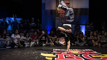 A breaker in action upside down during a Red Bull BC One contest.