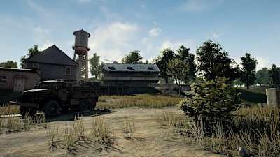 A promo image from PUBG showing some buildings, an old truck and trees.