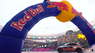Screenshot des Audi S1 EKS RX quattro unter dem Red Bull-Bogen im Playgrounds-Modus von DiRT 5.  Neue Wetterbedingungen wie Sturm und Regen, sowie neue Objekte sorgen für Abwechslung