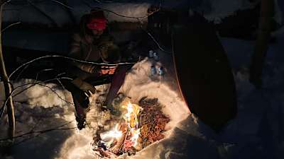 Durrell Borden sits by fire near Lawrencetown, Nova Scotia. 