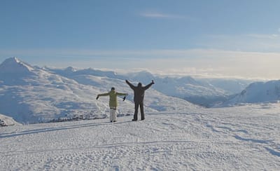 Alba Pardo & Markus Fischer arms in the air at Thompson's Pass Alaska
