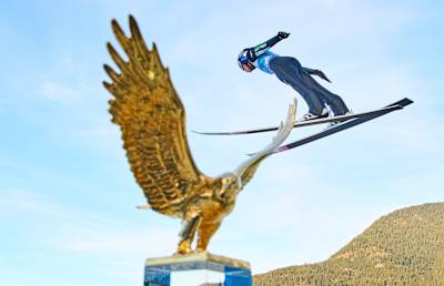 Kobayashi podczas rywalizacji w Turnieju Czterech Skoczni 2022 na tle Złotego Orła, głównej nagrody w evencie