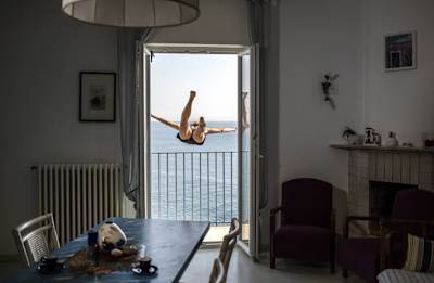 Gary Hunt of the UK dives out of an apartment during an early morning video production prior to the Red Bull Cliff Diving World Series at the Polignano a Mare, Italy on July 21, 2017.