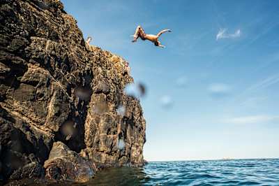 Cliff diving into freezing water.