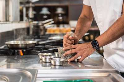 Chef Thomas Zacharias grinds food with a mortar and pestle