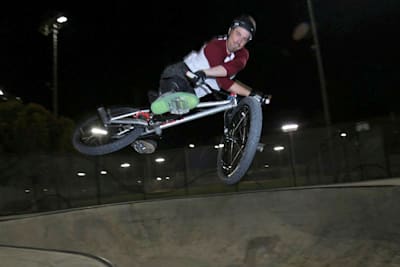 BMX rider Kurt Yeager does an x-up at a skatepark