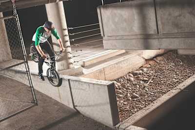 BMX rider Adam Banton does a hang 5 grind on a ledge in 2012