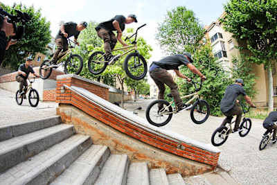 BMX rider Chad Kerley does a barspin to manual on a stair ledge