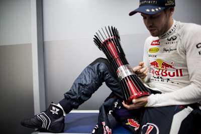 Sebastian Vettel of Germany and Infiniti Red Bull Racing poses for a photo in his changing room after winning the Formula One Grand Prix of India