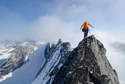 Tommy Baynard walks along a knife edge ridge, Alaska