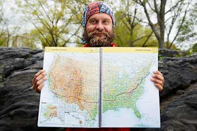 Ultra-runner Patrick Sweeney with the map of his trans-America running route from Los Angeles to Boston, which he completed in 114 days