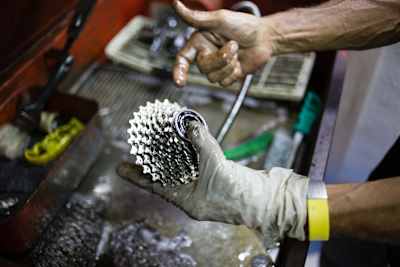 A bike cassette is washed and checked for wear and tear