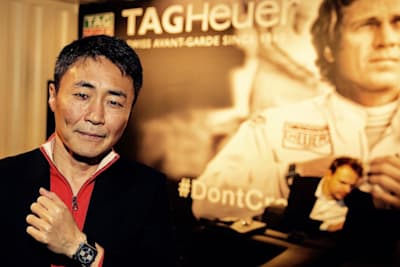 A photo of Kazunori with hero Steve McQueen at Geneva Motor Show