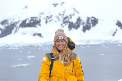 Cassie De Pecol holds in the snow in Antarctica.