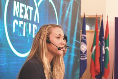 Cassie De Pecol speaking at a conference; she met with leaders and influencers in each different country.