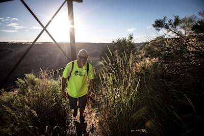 Daisher hikes out at dawn after jump number 55 He's still smiling after being up all night long.
