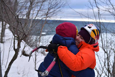 Sasha DiGiulian and Angela VanWiermeersch are seen hugging after successfully climbing ice in Michigan's Upper Peninsula, USA.