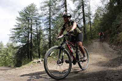 A rider competes in the cross-country marathon stages of MTB Shimla.