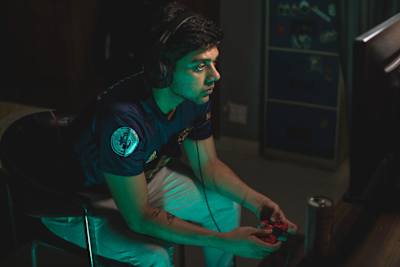 Lokmanyu Chaturvedi sits in his home setup in his favourite jersey and plays FIFA with his red and black controller while having Red Bull.