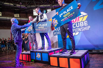 Winner Feliks Zemdegs gets congratulated by Rubik's Cube creator Erno Rubik.