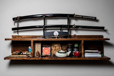 Zavěšená police na katany a symboly zobrazující různé duchovní víry