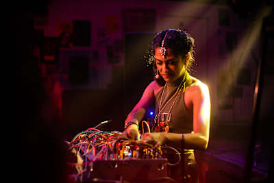 Arushi Jain aka Ose performs on a synthesizer during a show.