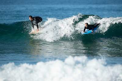 Sam surfs with her son, Noah, at Bilgola.