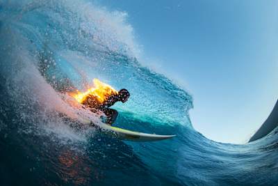 Jamie O'Brien surfs whilst lit on fire, at Teahupoo, Tahiti