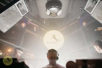 S.A.S.H founder Kerry Wallace DJing at a party.