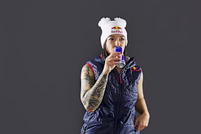 Grace sips on Red Bull with a look of pondering