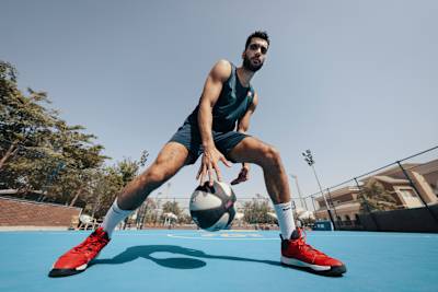 Basketball player Ehab Amin dribbles the ball.