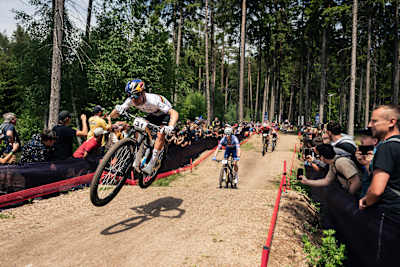 Tom Pidcock during mid-air jump at at UCI XCO World Cup in Nove Mesto na Morave, Czech Republic on May 26, 2024