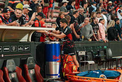 Julien Marchand, a player with Stade Toulousain, takes the time to sign autographs for supporters after a rugby match.