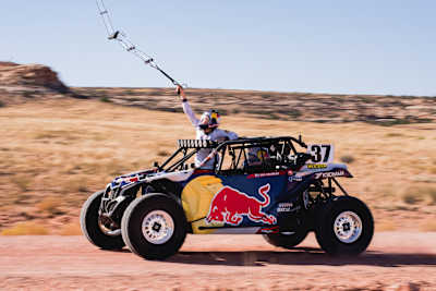 Red Bull Air Force Sky Diver Amy Chmelecki reaching out of the UTV