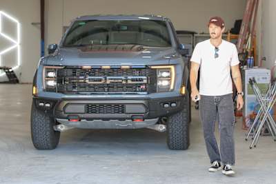 Host Riley Harper poses with a Ford Raptor