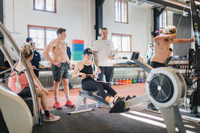 Catie Munnings pushes her limits during a HYROX workout at the Red Bull Athlete Performance Center in Thalgau, Austria, on January 9, 2025, surrounded by fellow Red Bull athletes.