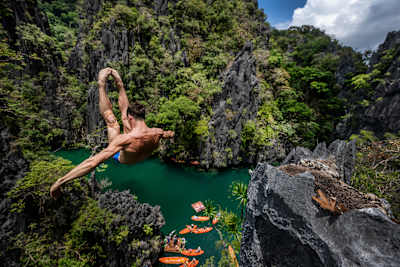 Romania's Constantin Popovici executes a stunning 24.5m dive during the 2025 Red Bull Cliff Diving World Series at the picturesque Small Lagoon in El Nido