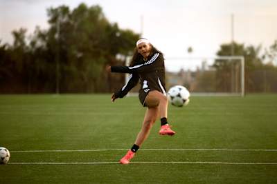 Trinity Rodman kicking a soccer ball