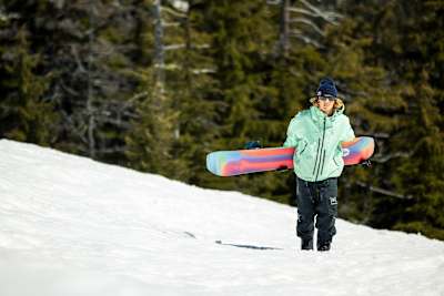 Brock Crouch hikes a feature at Landing Gear, Mt Bachelor