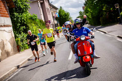 Filip Flisar 4. maja 2025 na teku Wings for Life World Run v Ljubljani (Slovenija) z duhom vodi tek in ponazarja Red Bullovo dinamično tekmovalno energijo