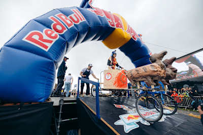 Participants launch a boldly designed soapbox car under the iconic Red Bull arch during Red Bull Olabil 2025 in Trondheim, Norway, thrilling the excitement-packed crowd