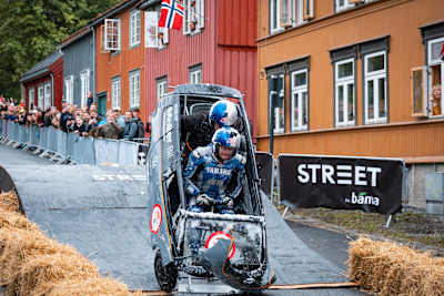 A thrilling moment at Red Bull Olabil 2025 in Trondheim, Norway, as competitors race a creative soapbox car down the city streets before cheering crowds